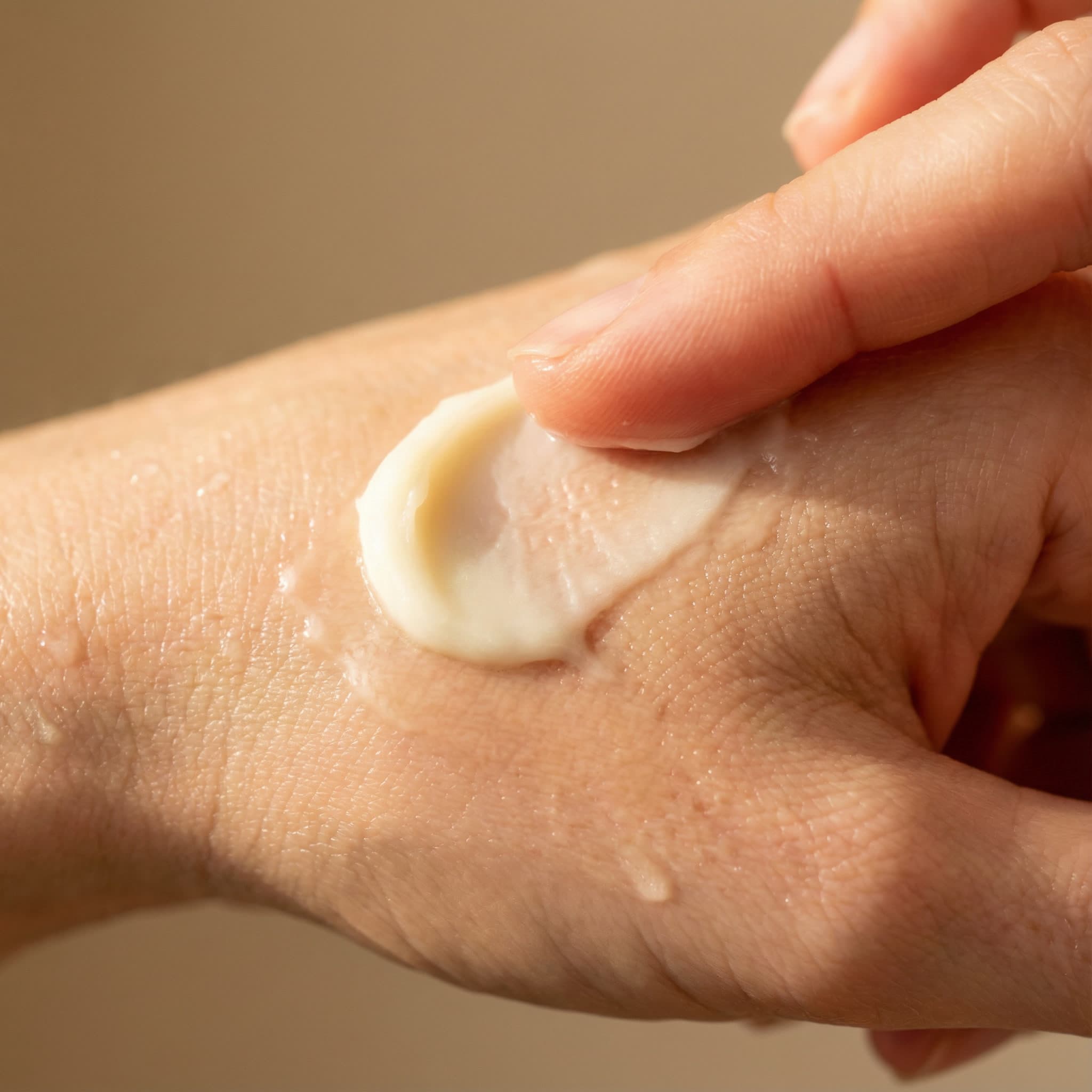 Close-up of Royal Tallow Cream being applied to skin - smooth, luxurious texture